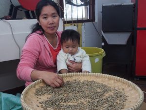 TENDER LOVING CARE -   A worker with her child at PGFI’s coffee-roasting facility, also in Sitio Padcal 