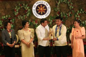 TUBLAY DANGAL NG BAYAN. Abner Lawangen, the Local Disaster Risk Reduction and Management Officer of the municipality of Tublay, Benguet, accompanied by his daughter Jennifer, receives the Dangal ng Bayan Award from President Rodrigo Duterte during the awarding of outstanding public officials and employees of exemplary public servants for the 2016 Search for Outstanding Government Workers at the Malacanang Palace on December 19, 2016. From left to right: Ombudsman Conchita Carpio Morales, Civil Service Commission Chairperson Alicia Bala, President Rodrigo Duterte, Abner Lawangen and Jennifer Lawangen. Photo by Rey Baniquet PCOO / PIA-CAR.