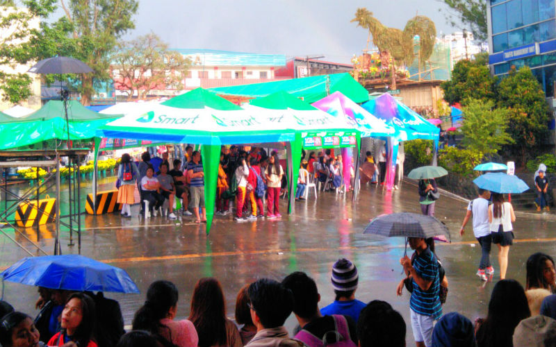 RAIN ON PARADE. Several years back, it was so difficult to see a raindrop from the dry January to March. Now, downpours during Panagbenga celebrations are consistently becoming a common sight. The 2017 Session Road in Bloom was not spared by this February 28 quick shower despite the sun appearing in the sky, Photo by ARMANDO BOLISLIS
