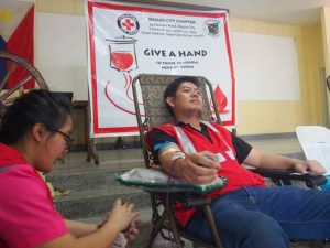 MINE BLOOD - Lawyer Rodolfo Bondad, assistant manager at the Legal Department of Philex Mining Corp.’s Padcal operations, is having his blood drawn by a Red Cross volunteer nurse at the offices of AM radio, dzWT, in the Bishop’s House Compound, Baguio City, as he takes part in a bloodletting during the 52nd Founding Anniversary celebration of the Mt. Province Broadcasting Corp. (April 23, 2017) MPBC